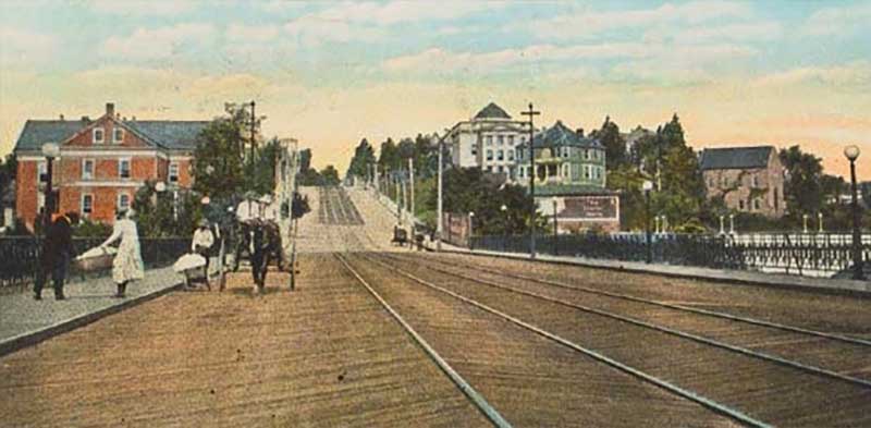 An old photo of trolley tracks on a wooden bridge